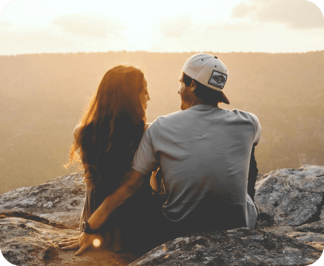 couple-sitting-at-sunset